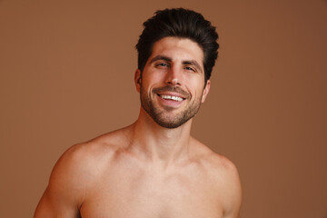 Happy half-naked man smiling and looking at camera