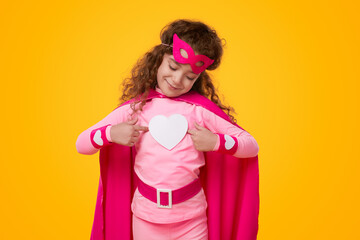 Little superhero kid girl with heart icon