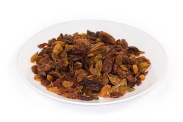 Dark yellow raisins on dish on white background, selective focus
