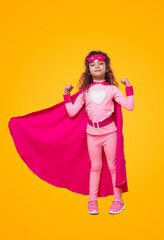 Strong little superhero kid girl showing muscles
