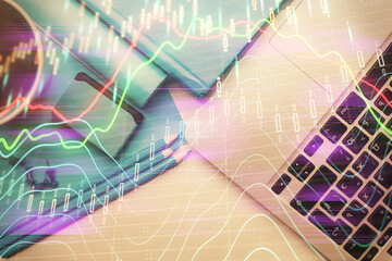Double exposure of forex graph drawing over desktop background with computer. Concept of financial...