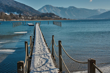 Snow covered landing stage in the lake Tegernsee in Bavaria, Germany.