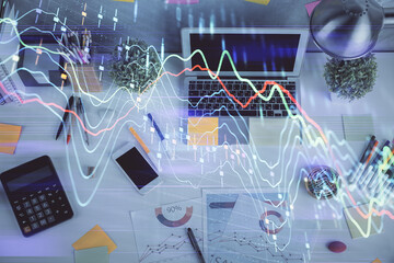 Double exposure of forex chart drawing over table background with computer. Concept of financial research and analysis. Top view.
