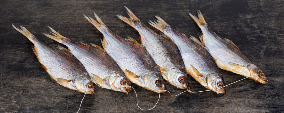Bunch of salted and dried roach on black surface