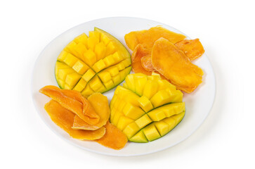 Dried mango slices and fresh cut mango halves on dish