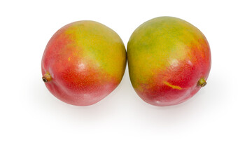 Two whole mango fruits on a white background