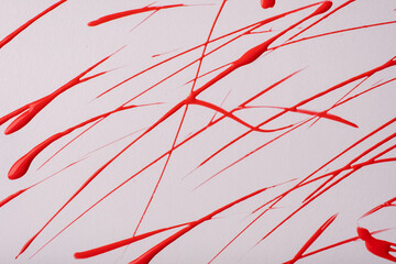 Thin red lines and splashes drawn on white background. Abstract art backdrop with brush decorative stroke.