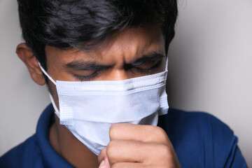  young sick man coughing and sneezes 