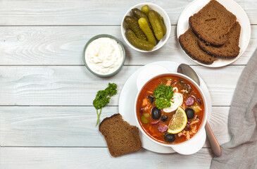 soup made from several types of meat. pickles, olives, lemon, sour cream, croutons, smoked sausage. Russian kitchen 