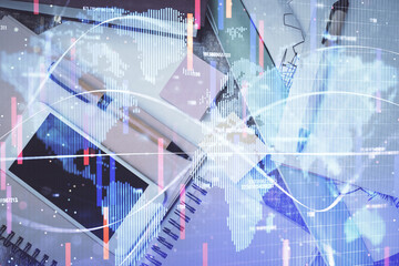 Double exposure of business theme hologram over desktop with phone. Top view. Mobile international trade connection concept.