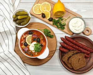 soup made from several types of meat. pickles, olives, lemon, sour cream, croutons, smoked sausage. Russian kitchen 