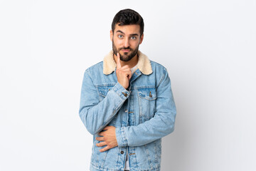 Fototapeta premium Young handsome man with beard isolated on white background and thinking