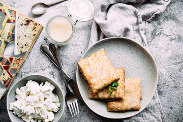 crepes with homemade cottage cheese on a gray plate