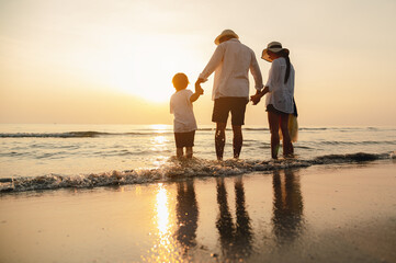 Happy asian family at consisting father, mother,son and daughter having fun playing beach in summer vacation on the beach.Happy family and vacations concept.