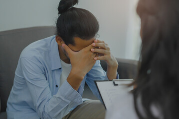 Men talk with a psychologist during talking therapy stressed mental health at office