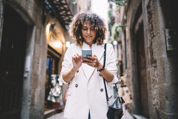 Millennial hipster girl connecting to 4g for browsing travel website reading web text on smartphone gadget, beautiful female tourist checking received email during online messaging via cell technology