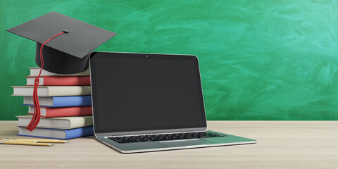 Online education concept with stack of books, graduate cap and empty black laptop screen on wooden...