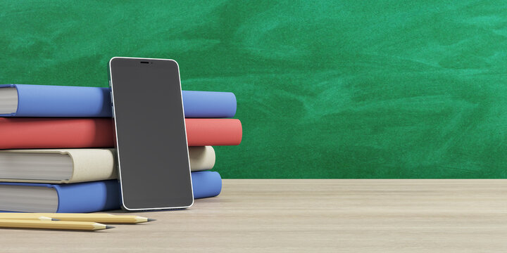 Online education concept with stack of books, pencils and modern cell phone black empty screen on wooden table at green chalk board background. Mockup