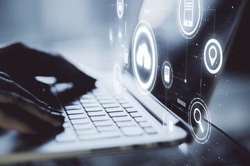 Data exchange concept with hands on laptop keyboard and virtual screen with cloud service application icons