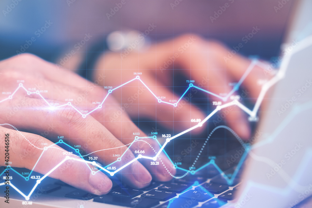 Poster Big data concept with man hands typing on laptop keyboard and digital glowing and growing statistic graphs