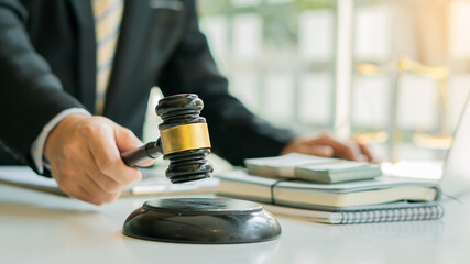 Male attorney advisor or judge advisor concept, having team meetings with clients, legal concepts and hammer attorneys with fair scales on desks in the office.