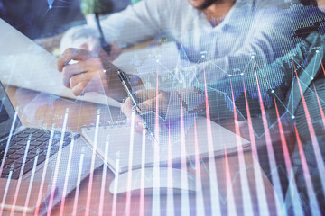 Double exposure of forex chart drawing over people taking notes background. Concept of financial analysis