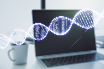 Double exposure of creative DNA hologram on laptop background. Bio Engineering and DNA Research concept