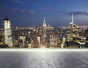 Empty concrete rooftop on the background of a beautiful New York skyline at night, mock up
