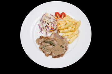 Steak with pepper sauce serve with french fries and salad.