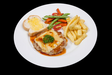 Fried piece of pork with vegetable salad on a plate close-up view from above. horizontal