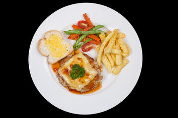 Fried piece of pork with vegetable salad on a plate close-up view from above. horizontal