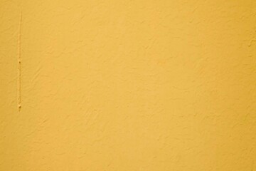 Vintage yellow painted concrete wall texture and background seamless