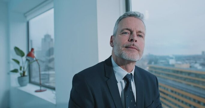 Close up of a businessman with blue eyes looking straight to the camera