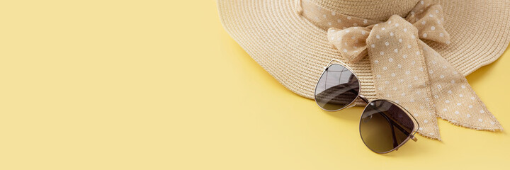 Straw hat and sunglasses on yellow background. Summer holiday, vacation, travel concept. Flat lay,...