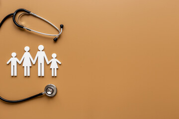 Wooden family figure with stethoscope. Life and health insurance concept