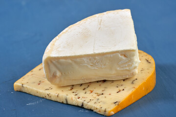 Aged cheddar and Camembert on blue