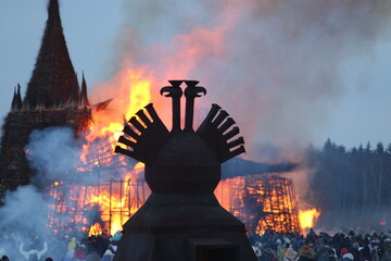 Symbol of Russia: two-headed eagle. Maslenitsa 2021. Traditional national holiday, folk game in...