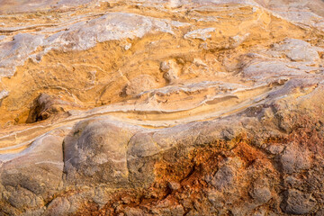 Light red-orange stone texture. Red orange grunge background. Mountain texture macro close-up. Bright colorful banner for your design.