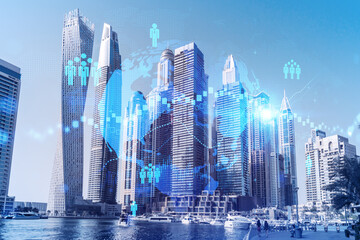 Skyscrapers of Dubai business downtown. International hub of trading and financial services. Social network icons hologram, concept of people connection. Double exposure. Dubai Canal waterfront.