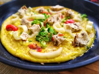 omelet with vegetables in a frying pan
