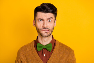 Fototapeta premium Portrait of focused young person biting lip look interested camera isolated on yellow color background