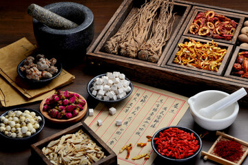 Ancient Chinese medicine books and herbs on the table