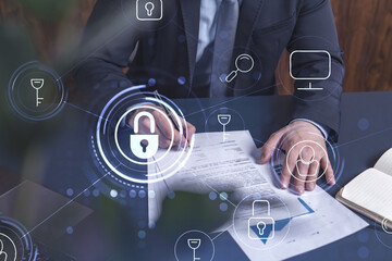 A businessman in formal wear signing the contract to prevent probability of risks in cyber...
