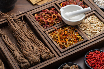 Ancient Chinese medicine books and herbs on the table