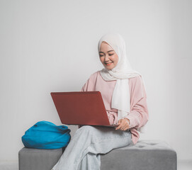 asian muslim student holding laptop in front of white background