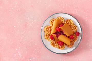waffles with Norwegian brunost traditional brown cheese and raspberry jam