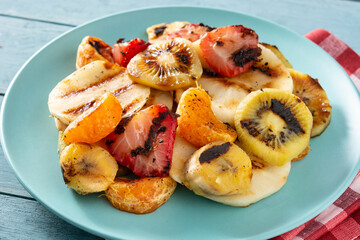 GRILLED FRUIT on a blue plate on wooden table