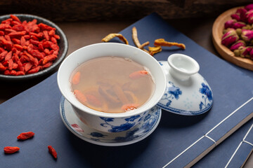 Traditional Chinese health tea and classical medical books on the table