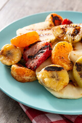 GRILLED FRUIT on a blue plate on wooden table