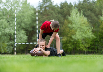Girls playing rugby together outside in summer. Woman sport concept